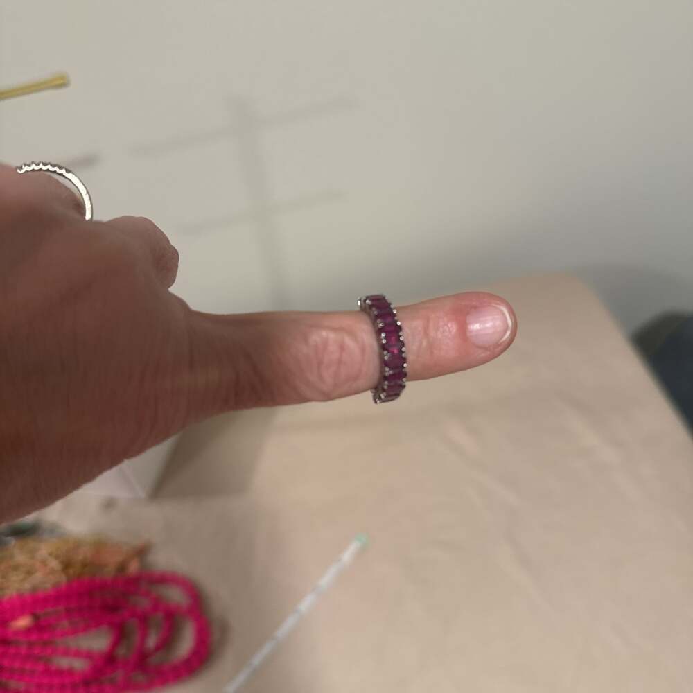 Red Emerald Cut Cubic Zirconia Eternity Band in Rhodium Plated Sterling Silver